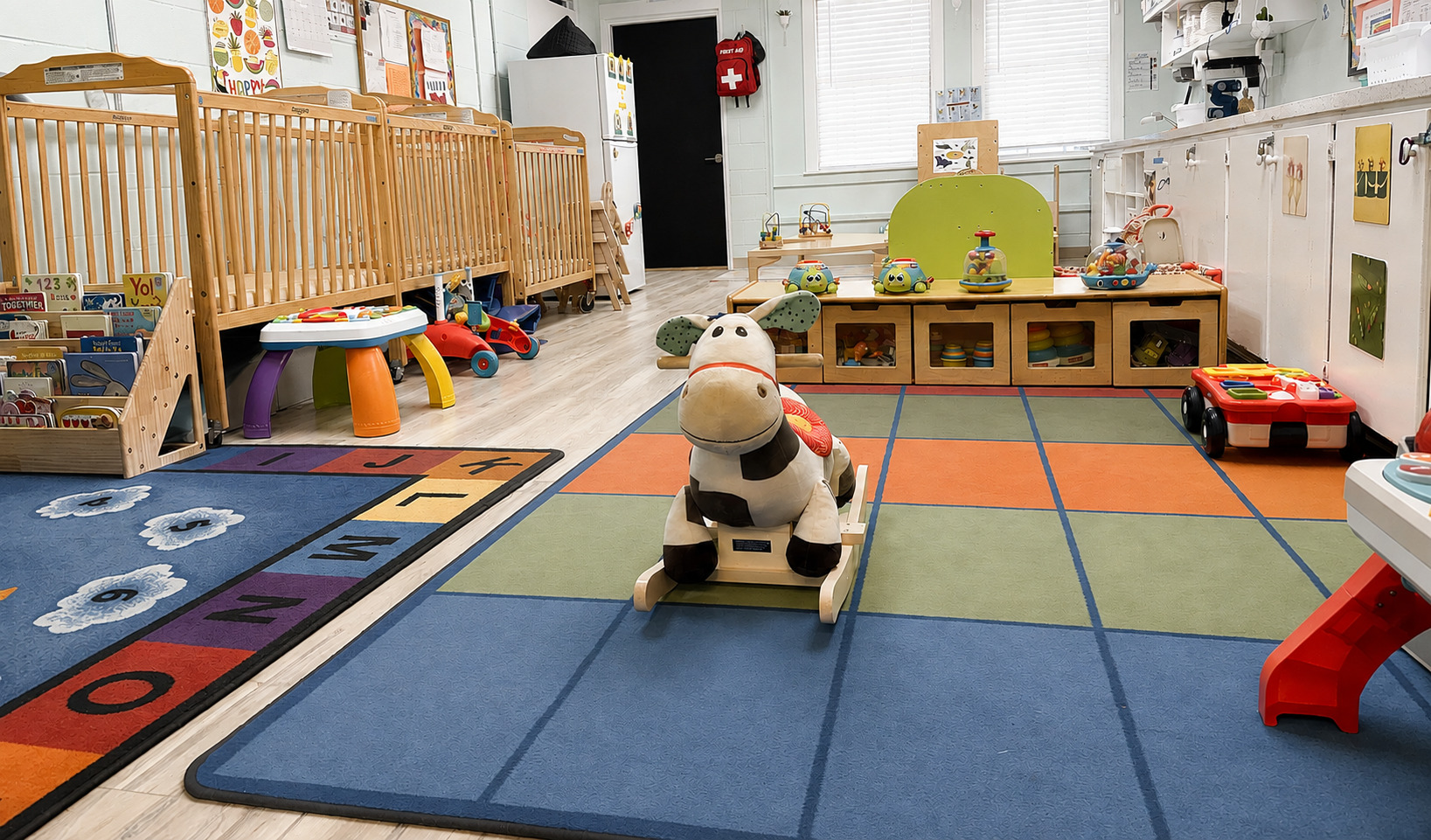 Infant room with soft lighting and caring teacher