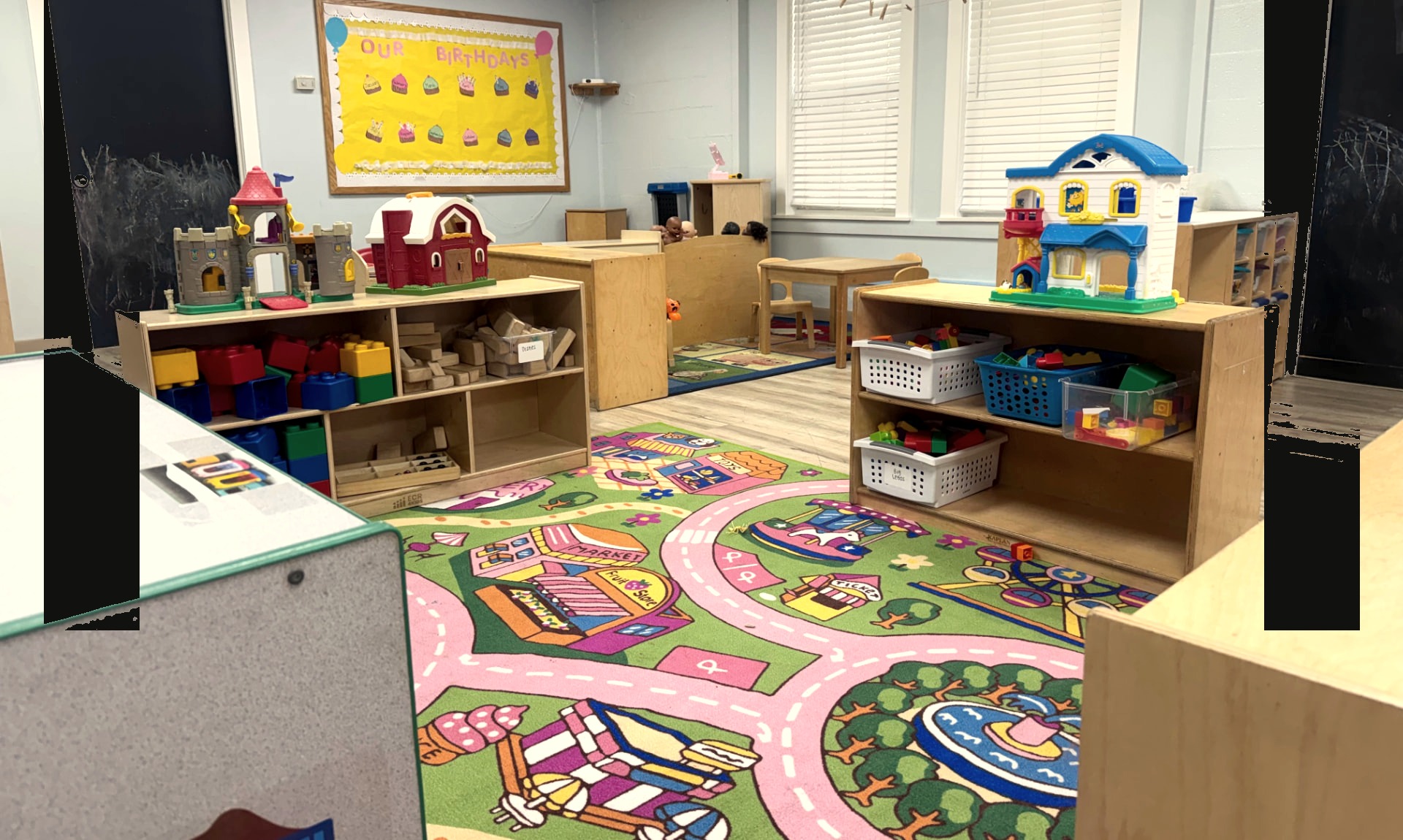 Two-year-old children playing with blocks and a teacher